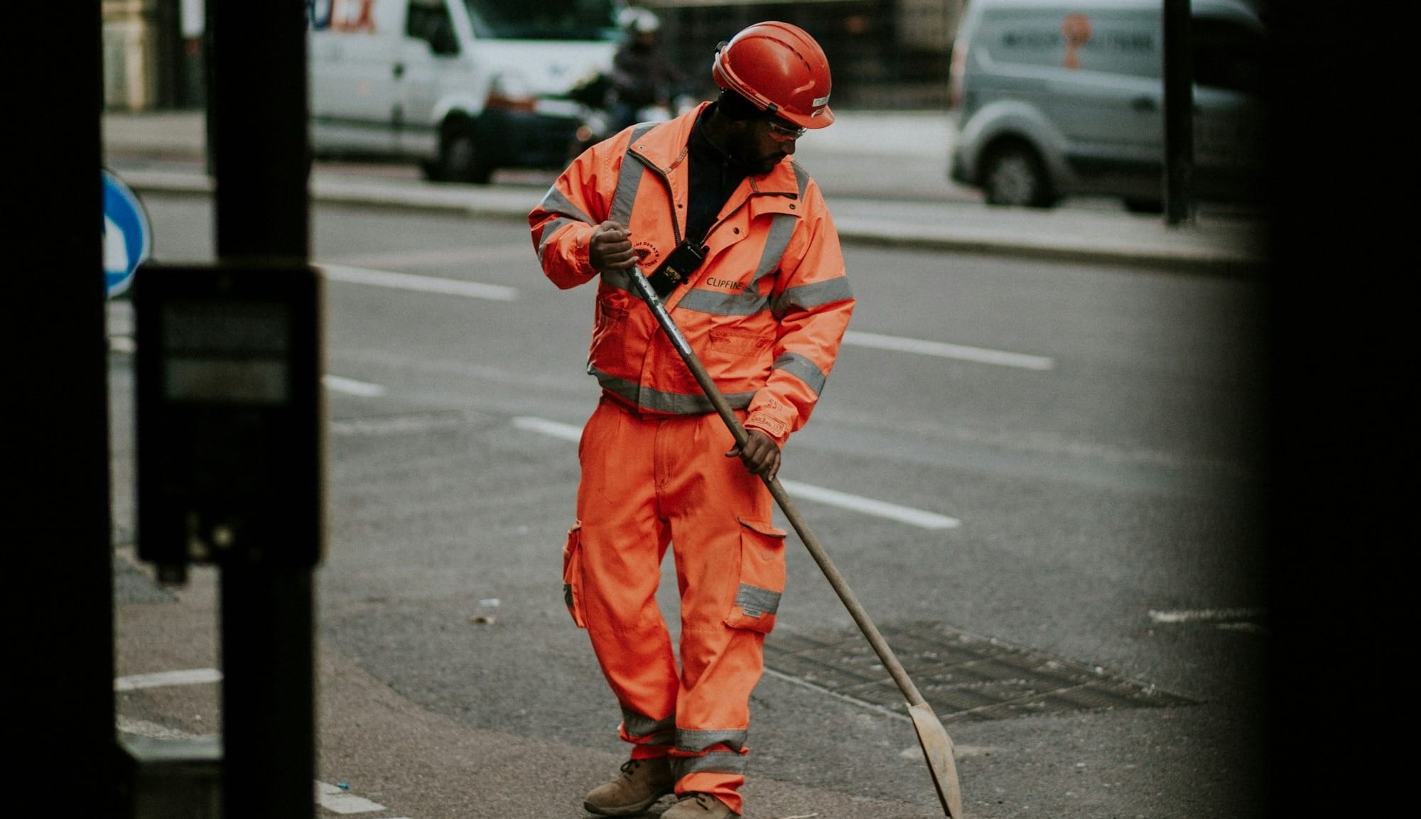 man wearing orange bunker gear on road