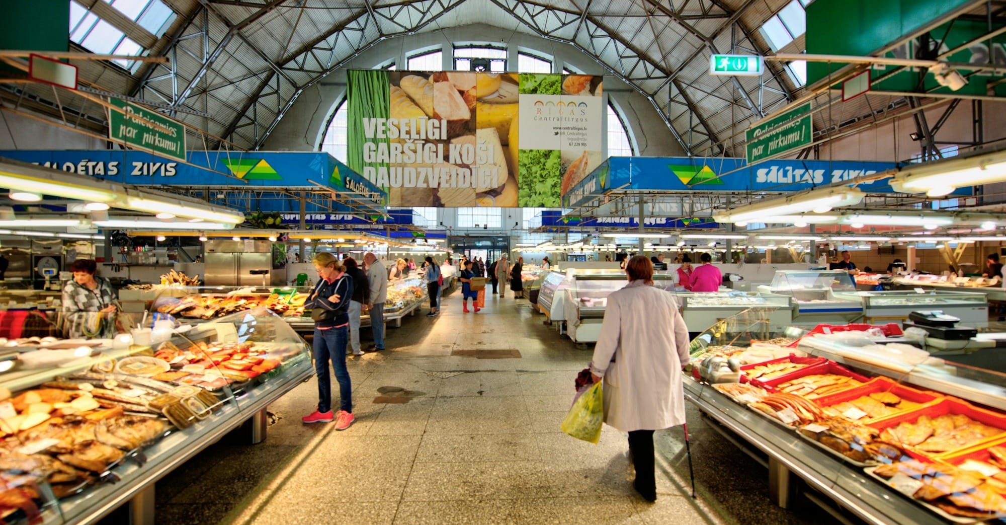 a woman is walking through a grocery store