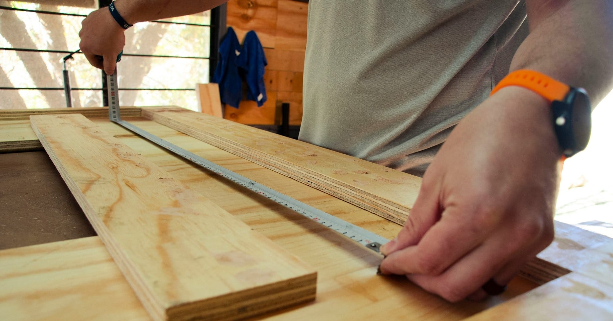 person in white shirt holding brown wooden table