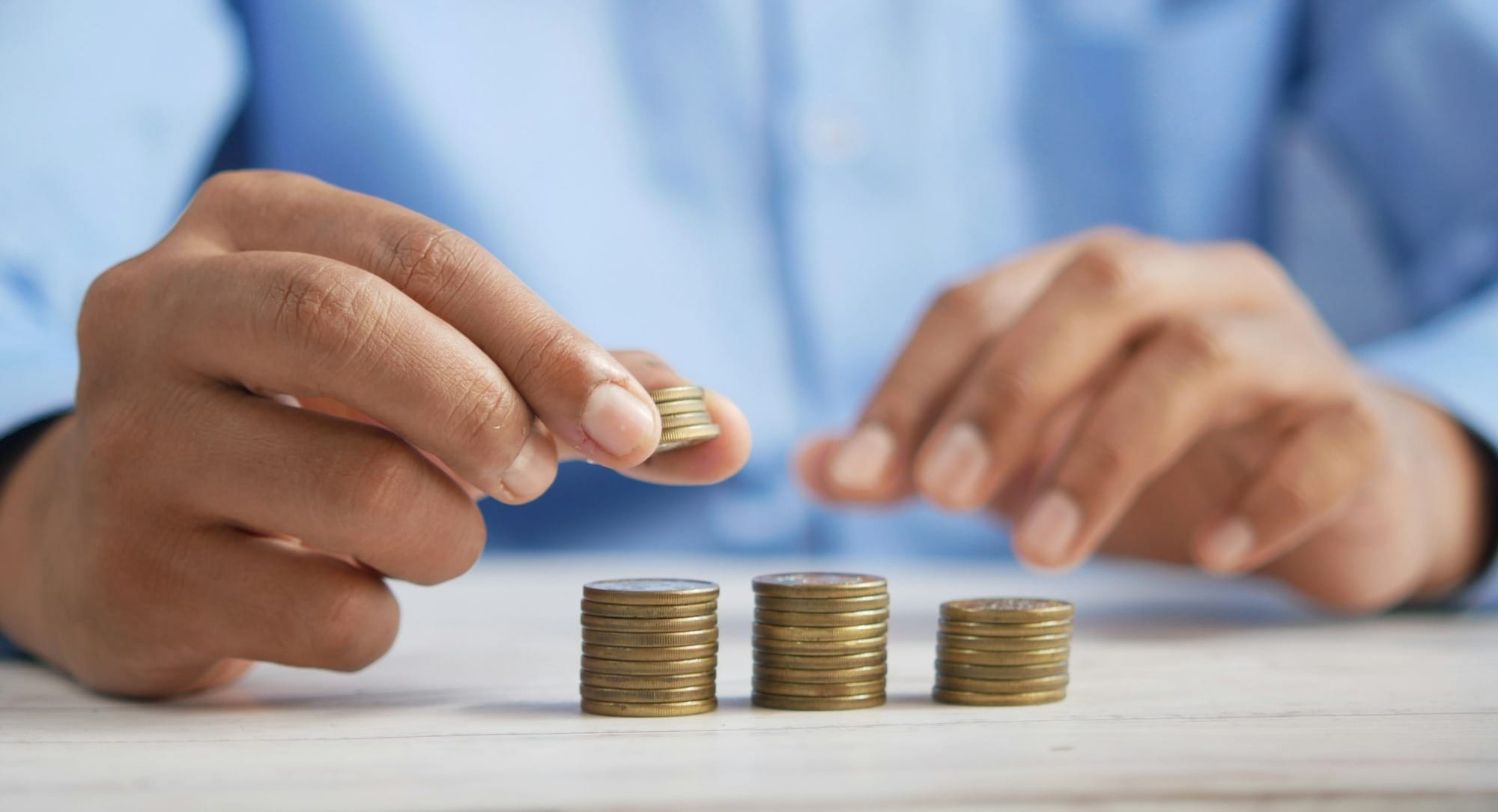 a person stacking coins on top of a table