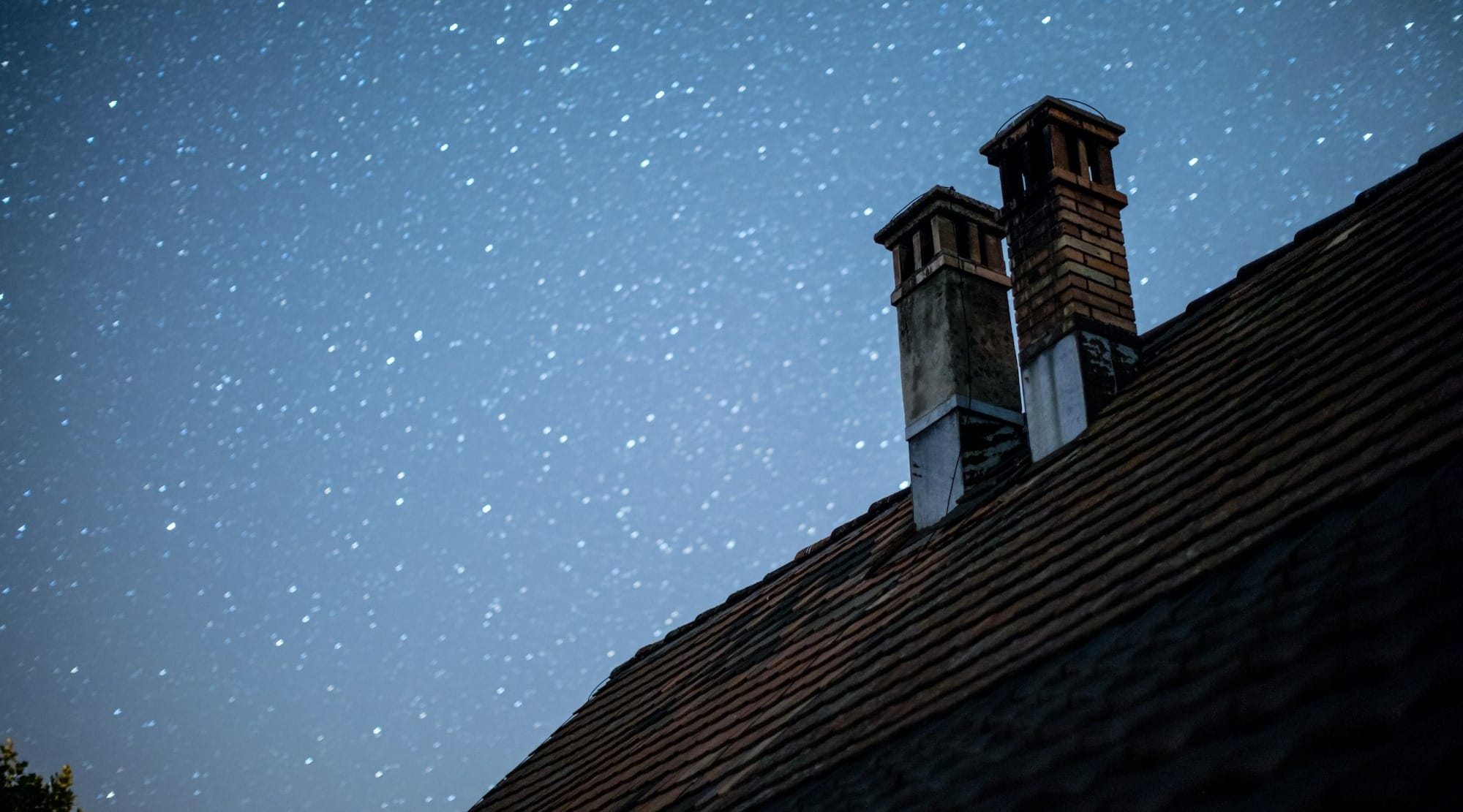 brown and black wooden house under starry night