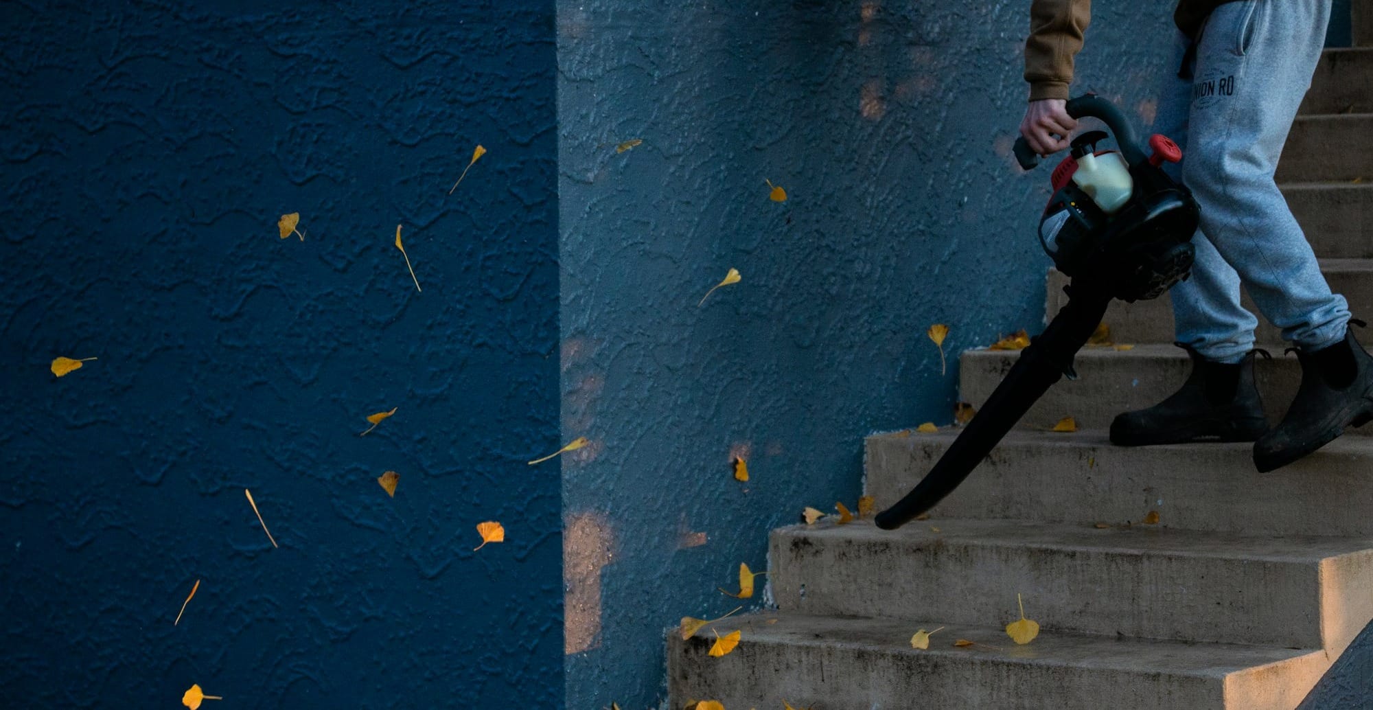 man in black jacket and pants standing on stairs