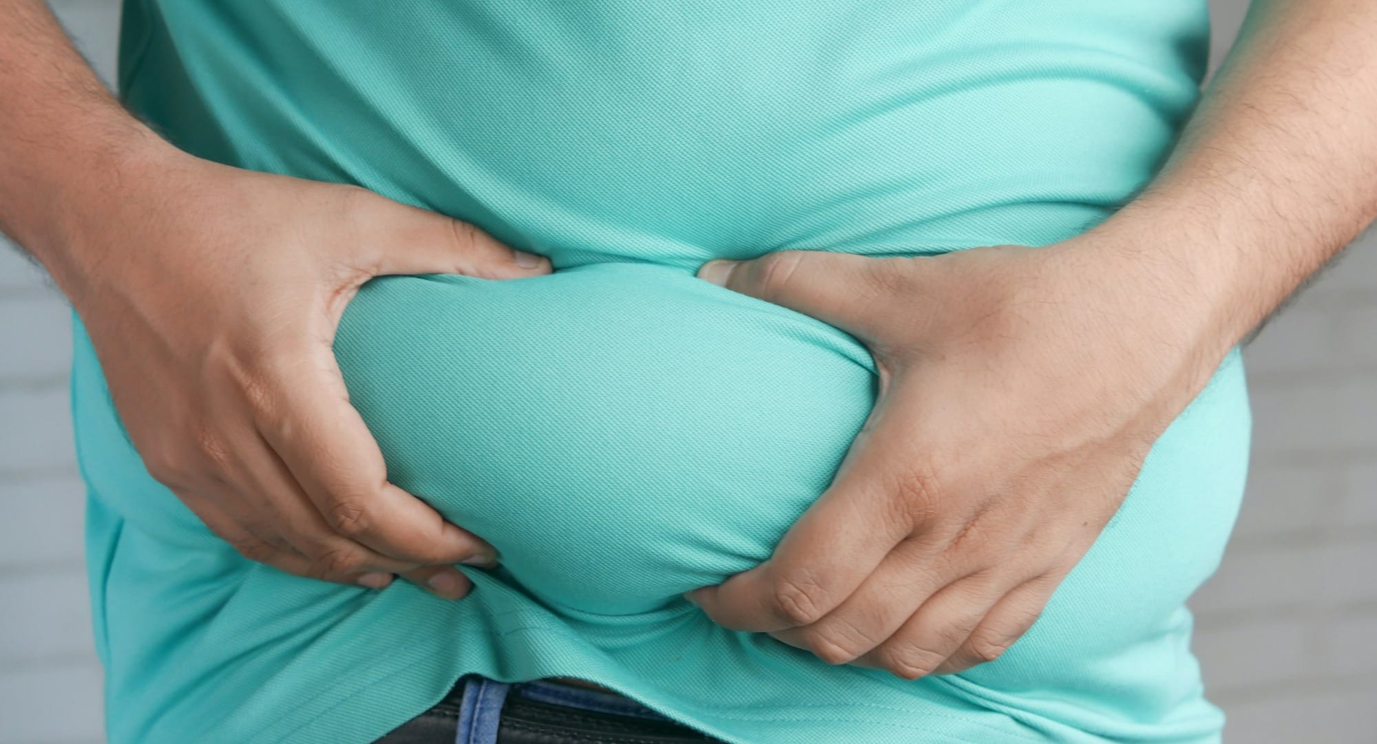 a man holding his stomach with his hands