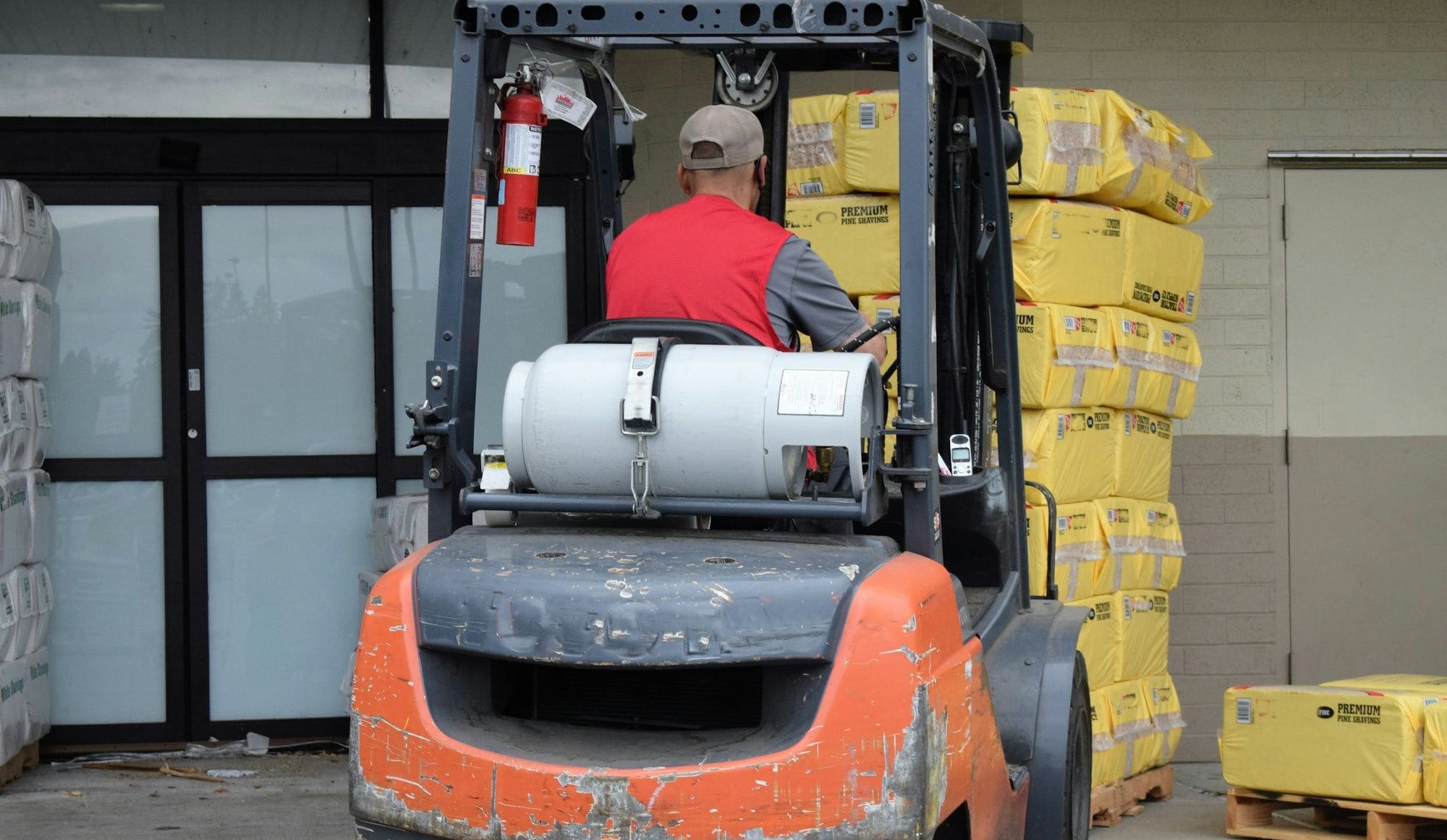 a man driving a forklift in a warehouse